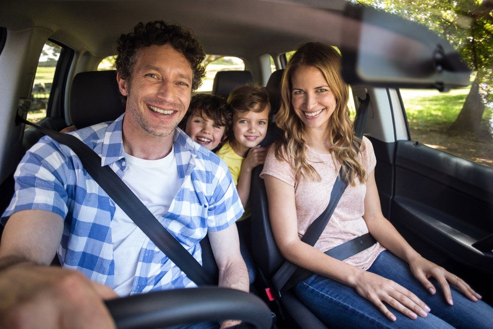 Happy Family In Car On Trip — Fast & Affordable Car Hires in Bilinga, QLD