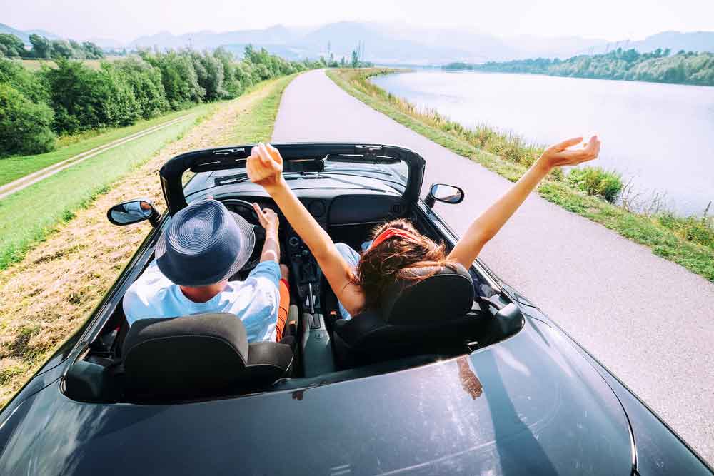 Couple In A Car Having A Great Vacation