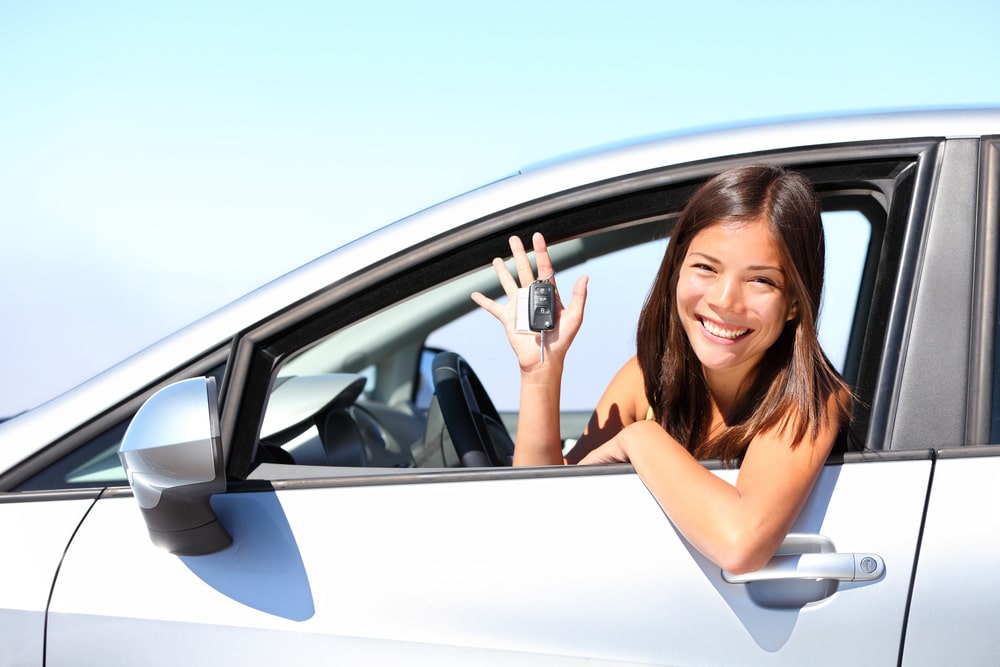 Young Woman Inside A Rental Vehicle