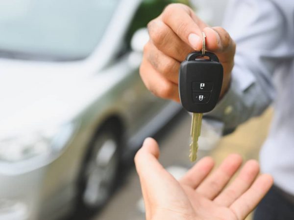 A Man Hands Over A Car Key