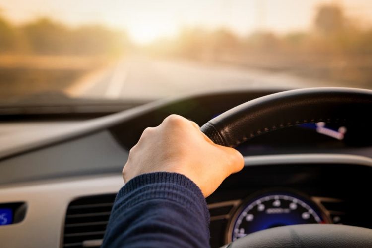 Man Driving Car On Road — Fast & Affordable Car Hires in Bilinga, QLD