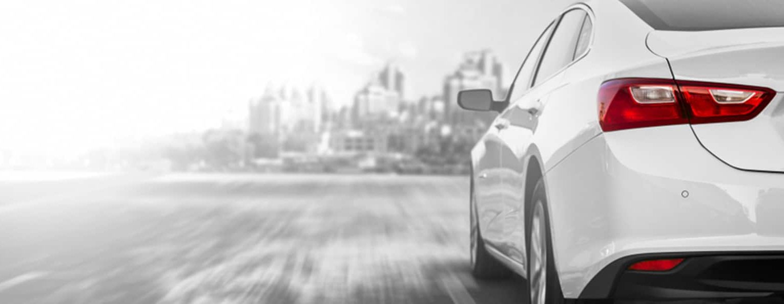 White Sedan Car Going to the City — Fast & Affordable Car Hires in Bilinga, QLD