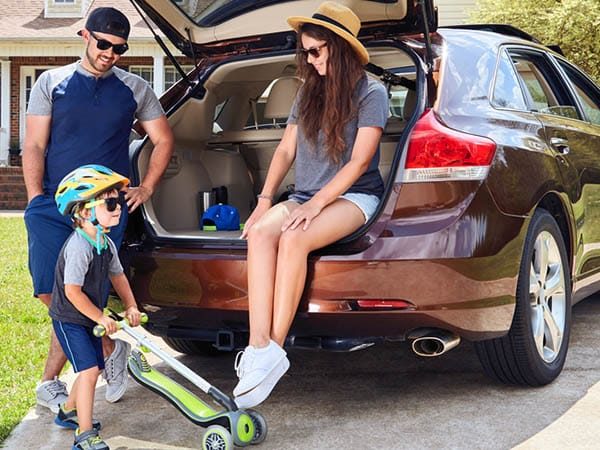 Happy Family at the Back of Car — Fast & Affordable Car Hires in Bilinga, QLD